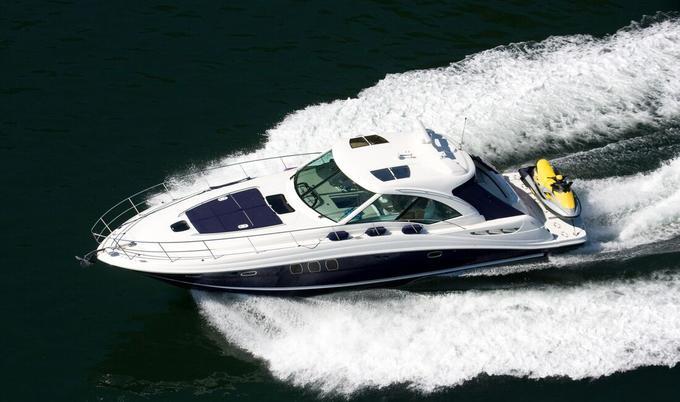 Aerial view of boat carrying personal watercraft. 