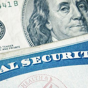 Stack of social security card and money
