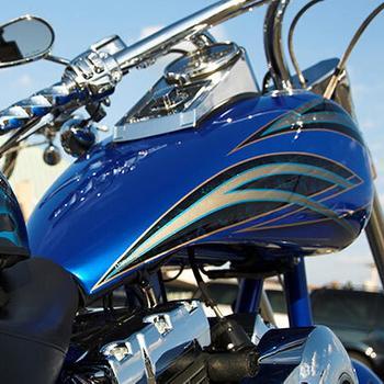 Close-up of a custom blue motorcycle with flames.