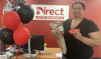 A woman stands holding flowers and Circle K gift cards