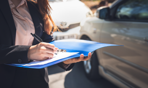 woman writing report after an auto accident 