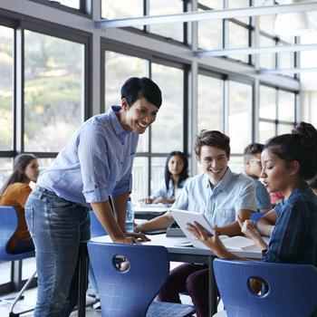 Professor talking to a group of students in class.