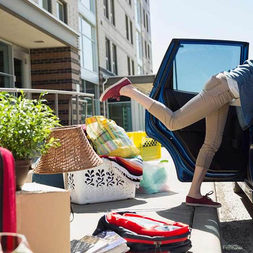 woman unpacking car at dorm