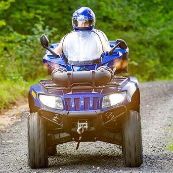 man on blue atv dirt road