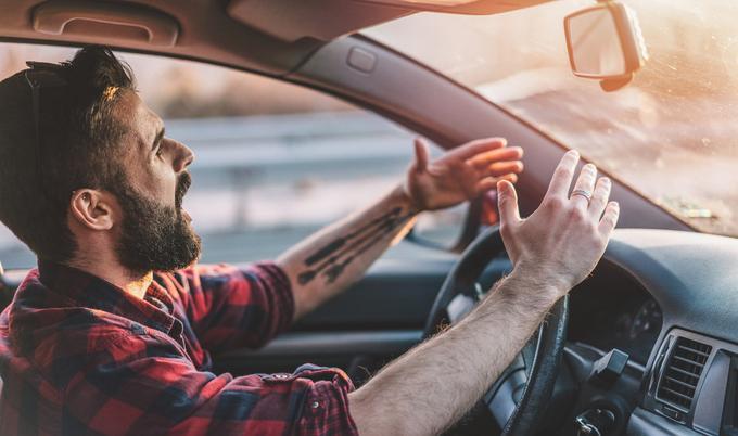 An angry man driving a car