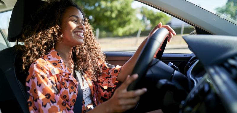 woman smiling and driving 