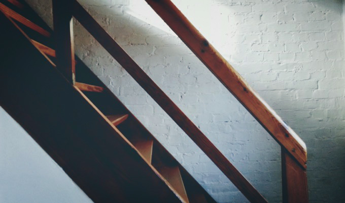 Wooden stairway against wall.