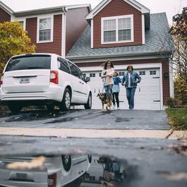 family walking dog outside