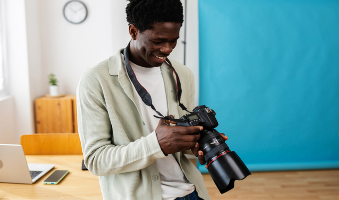Man looking at his camera after taking a photo