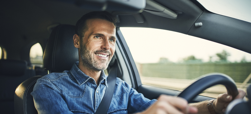 Handsome man driving a car.