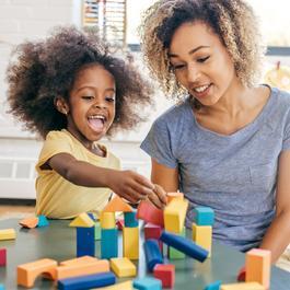 Mom and daughter playing with blocks.