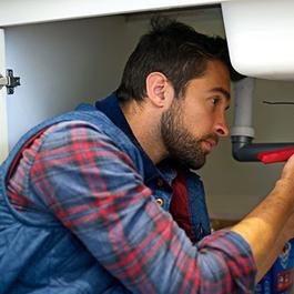 man fixing sink