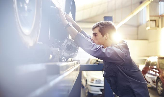 Mechanic examining car on a lift.