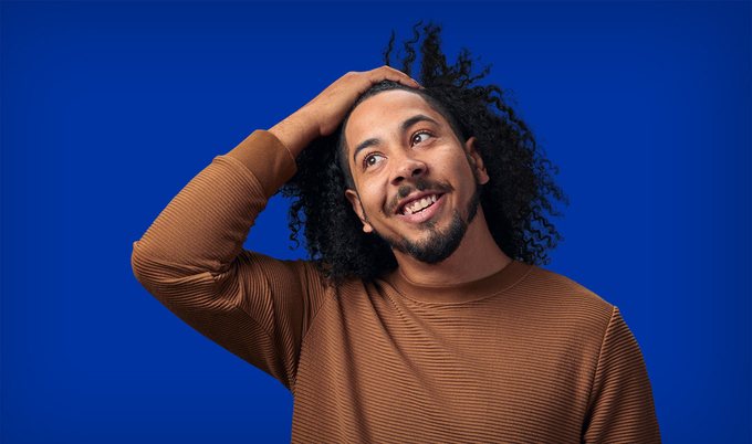 Man holding head smiling