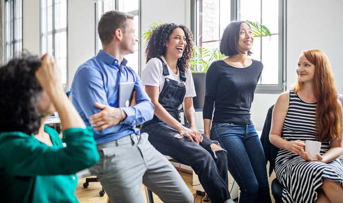 Co-workers in a conference room collaborating and enjoying their time together.