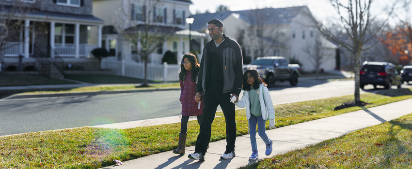Father walking his school aged daughters to school 