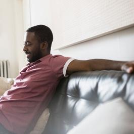 man with laptop sitting on couch