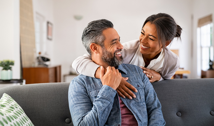 Couple smiling at each other at home