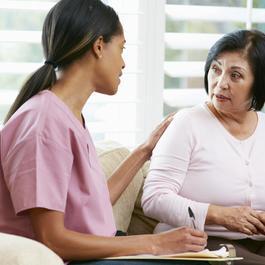 Nurse consulting mature woman.