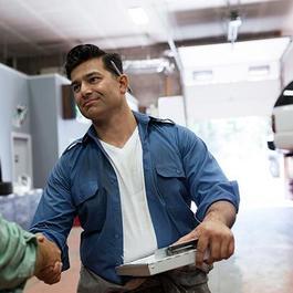 men shaking hands at collision repair shop