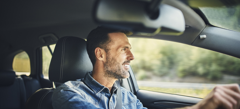 Handsome man driving a car.