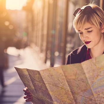 woman reading map on walkway