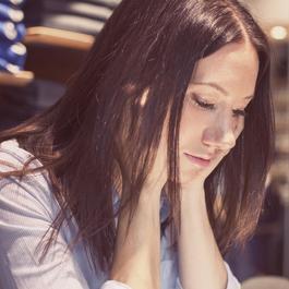 Serious woman looking down.