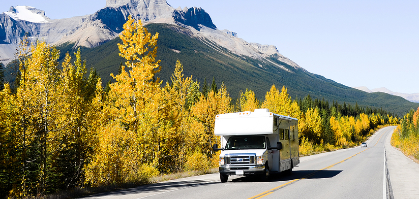 Motorhome on own road driving through mountains