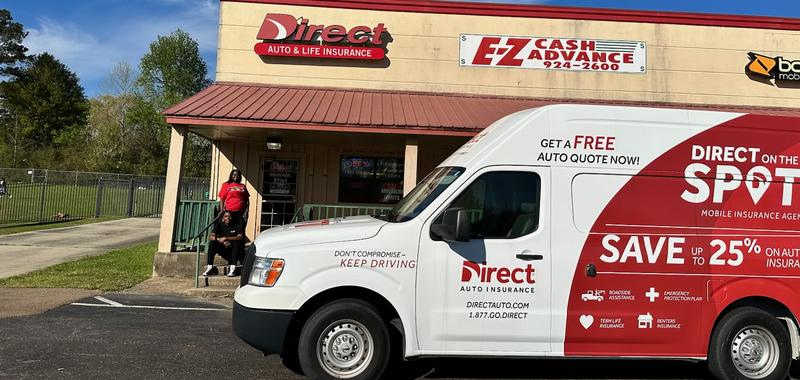 Two agents outside of a Direct Auto location with the Direct On the Spot Van.
