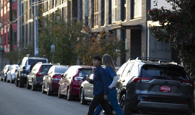 2 woman eating ice cream and walking
