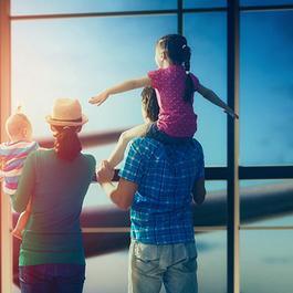 Family with two kids watch plane
