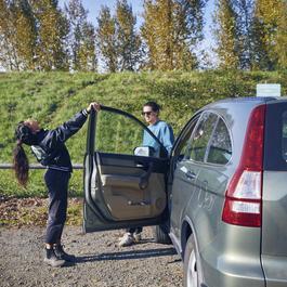 Couple hanging out outside of car