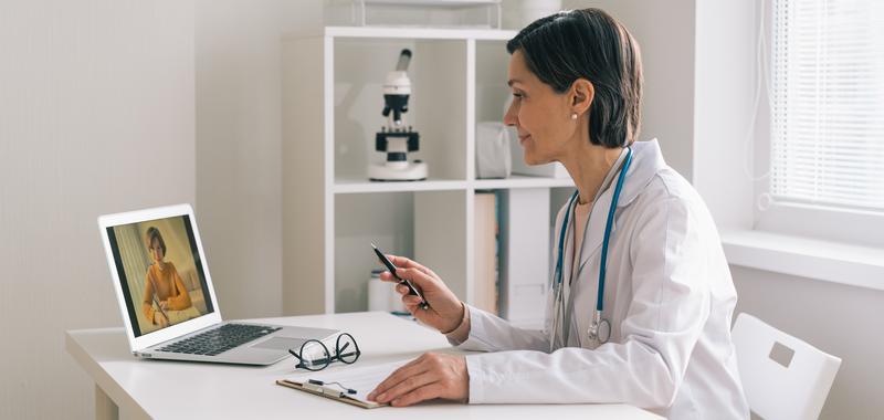 doctor consulting with patient virtually on a laptop