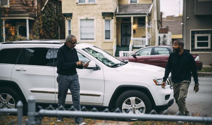 father and son getting out of car