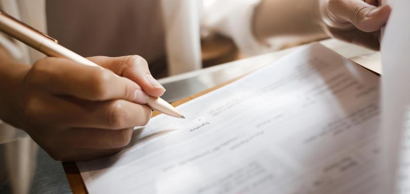 woman reviewing contract with pen 