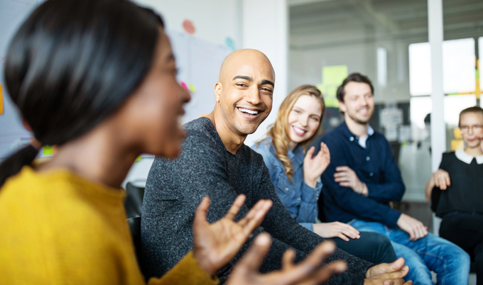 Co-workers sitting around a circle in a group discussion.