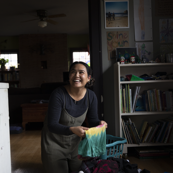 laughing woman doing laundry.