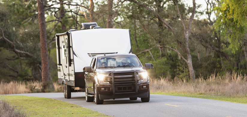 A camper trailer on a rural road