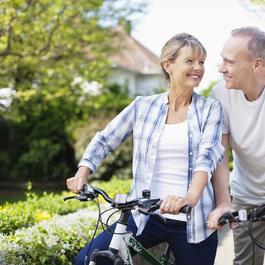 Man and woman sitting on bikes.