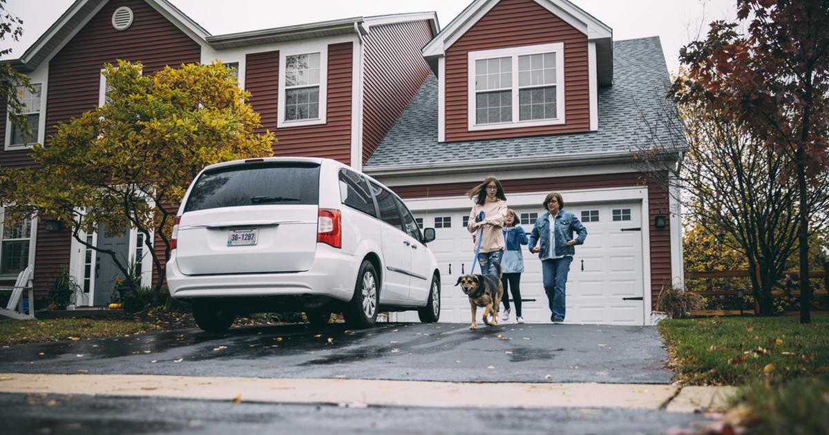 family walking dog outside