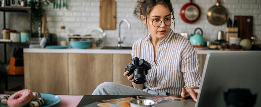 Young female food photographer working process
