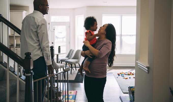 mom holding daughter