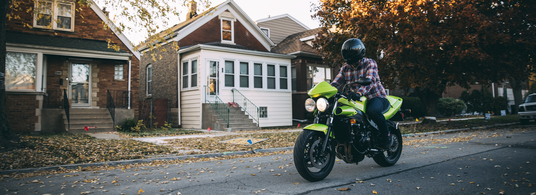 Man riding motorcycle down street