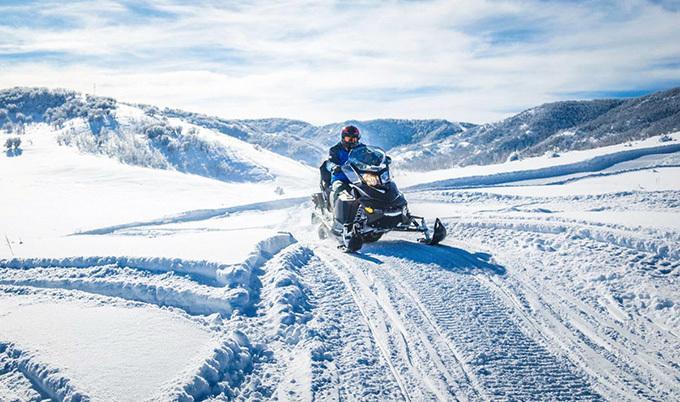 Snowmobiler on a trail in the snow