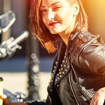 woman drinking coffee on motorcycle