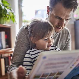 Father reading to daughter.