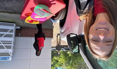 Two Direct Auto agents at a community event with the Direct on the Spot van and giveaways.