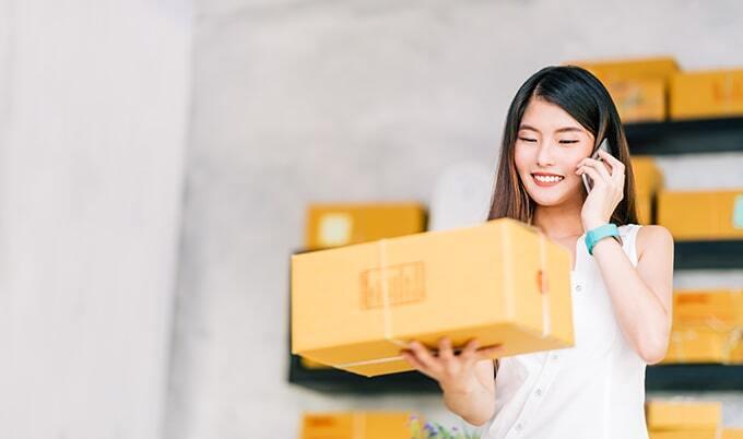 Woman on phone holds package