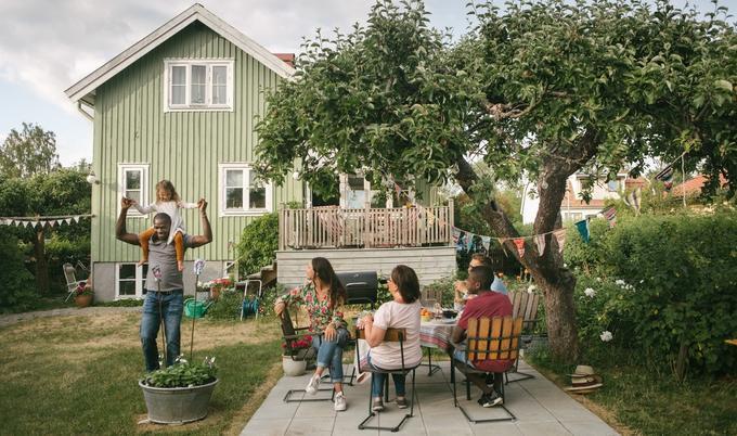 Family is relaxing and playing in backyard.