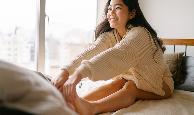 Woman stretching in morning in bed.